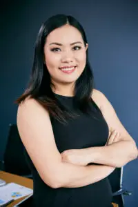 Portrait of smiling confident Vietnamese businesswoman in her office